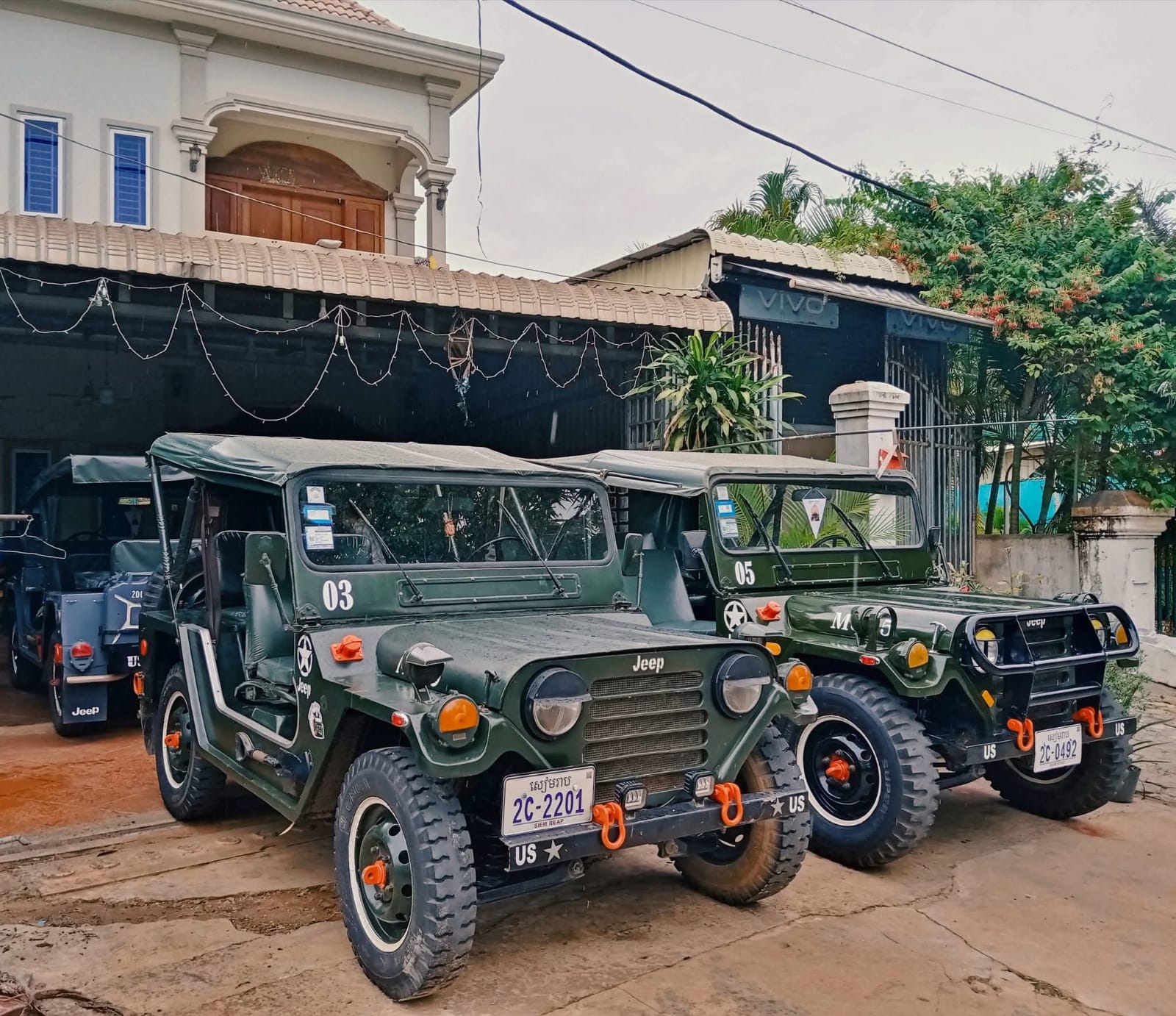 Fleet of vintage military Jeeps parked outside our Siem Reap base